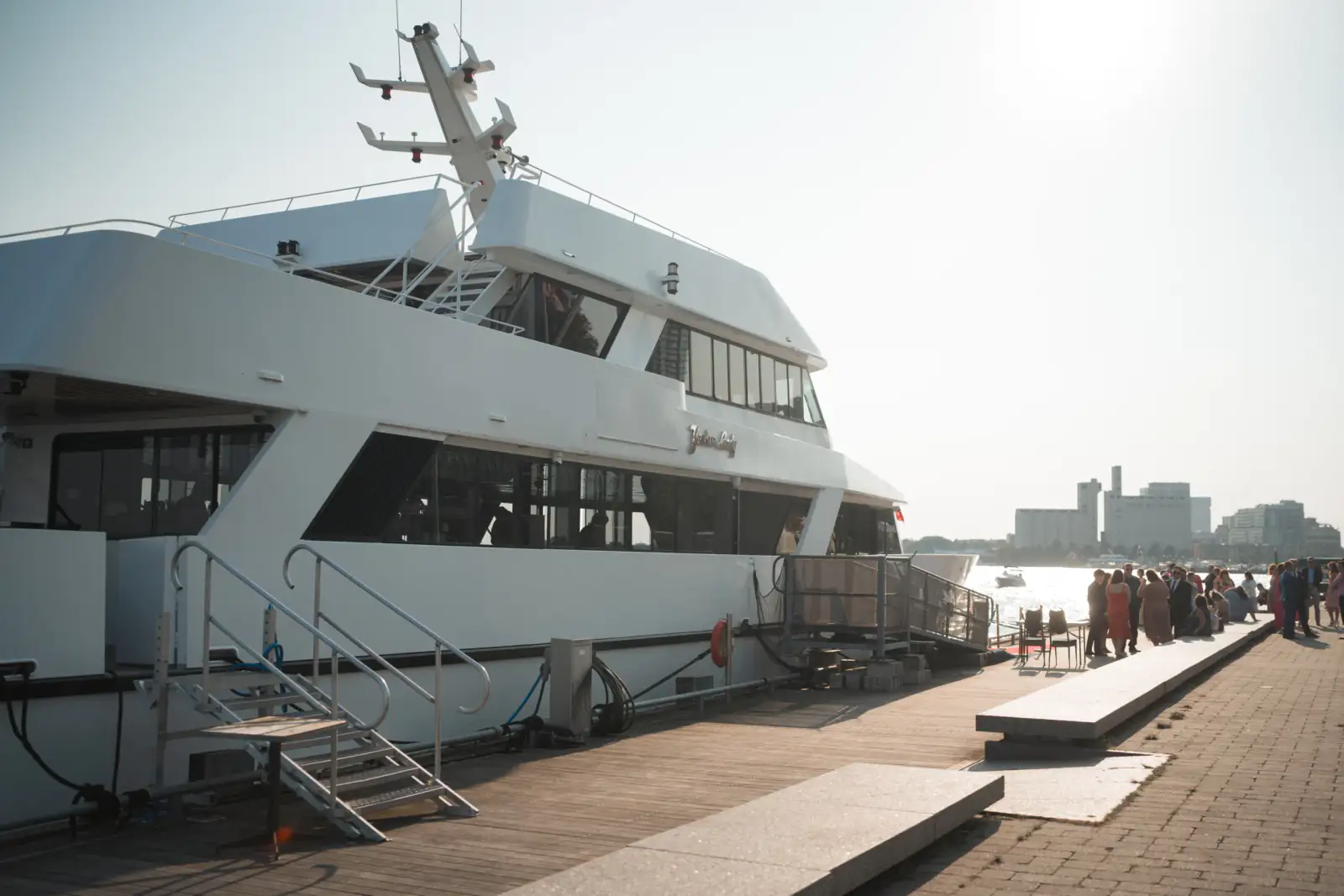 Guests gathering beside Yankee Lady in the evening light