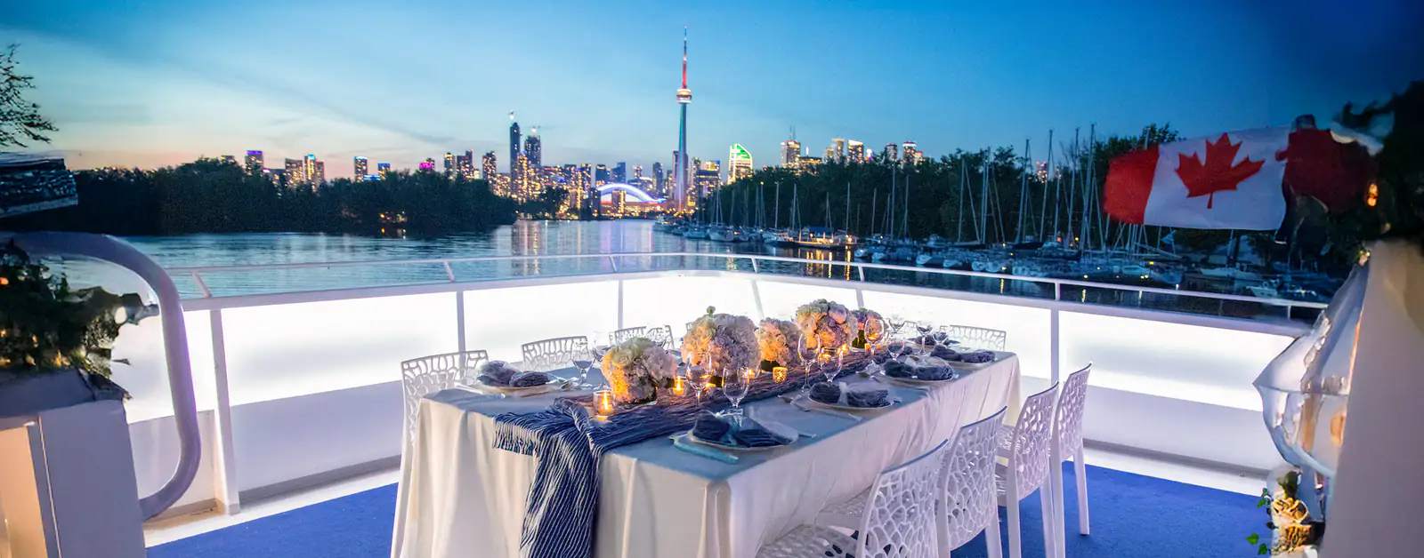 An elegant upper-deck dining setup overlooking the Toronto skyline